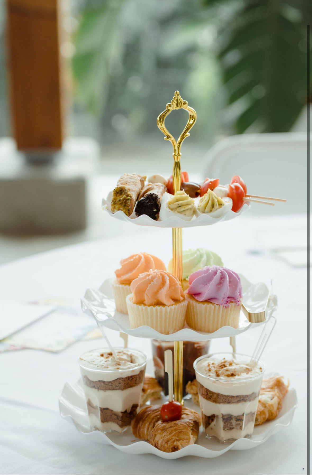 Tiered dessert tower with cupcakes and trifles