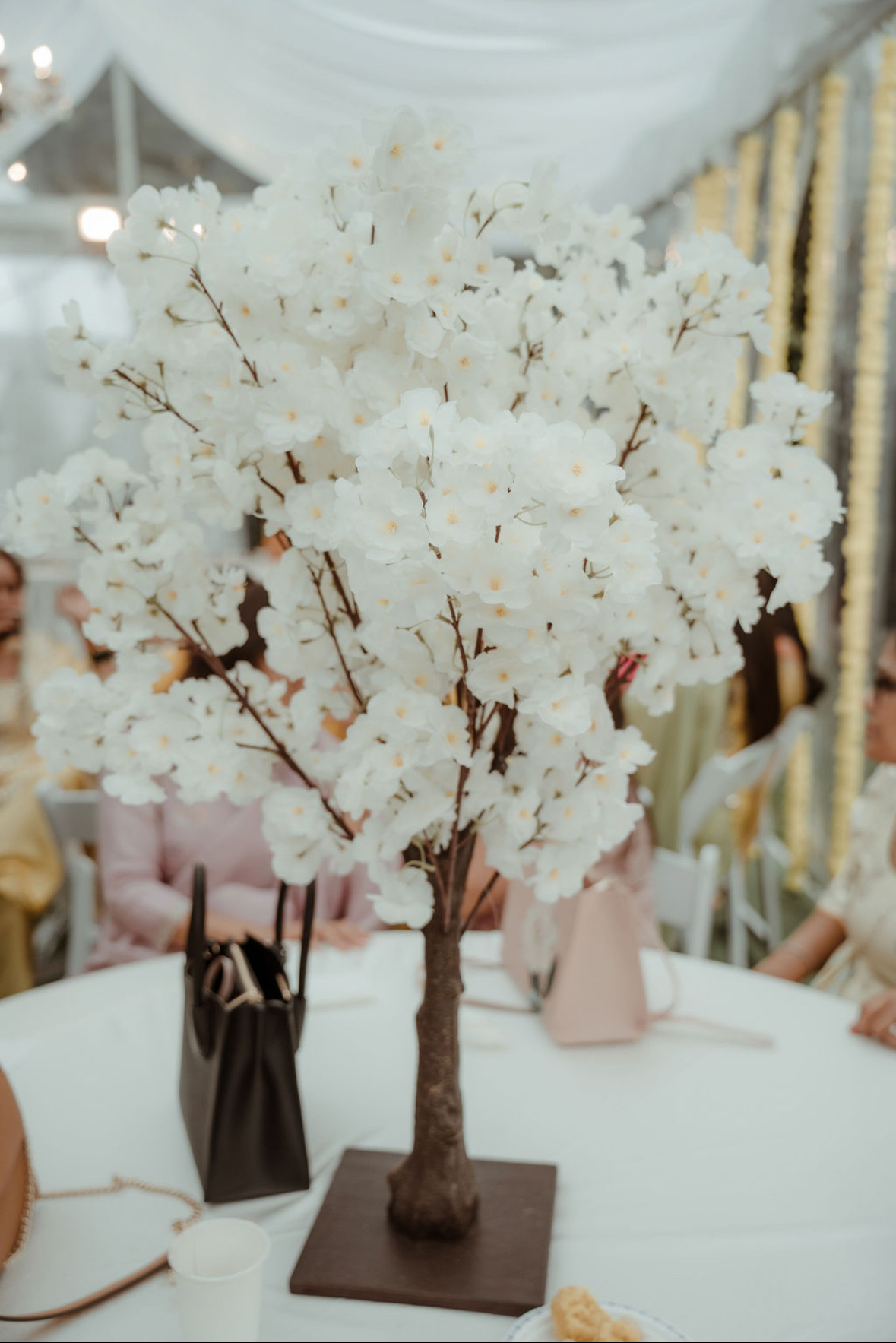 White cherry blossom tree centerpiece in tent